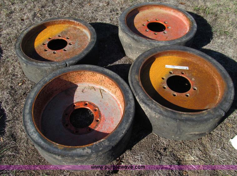 image for item O9000 (4) hard rubber skid steer tires and wheels