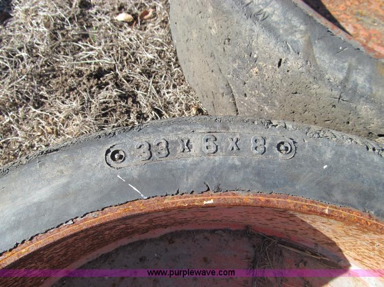 image for item O9000 (4) hard rubber skid steer tires and wheels