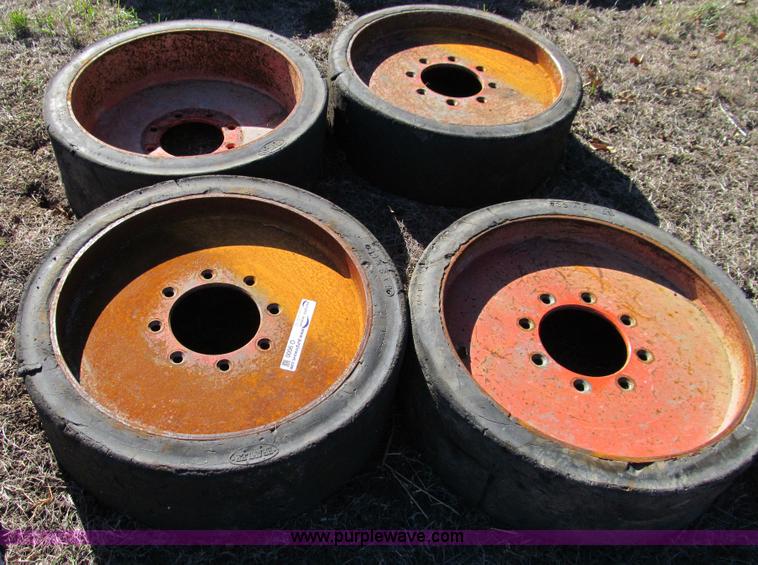 image for item O9000 (4) hard rubber skid steer tires and wheels