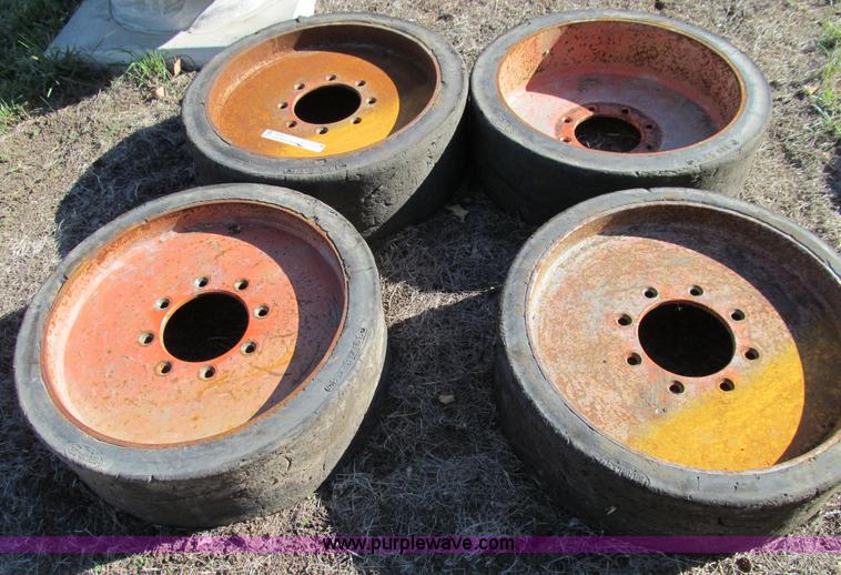 image for item O9000 (4) hard rubber skid steer tires and wheels