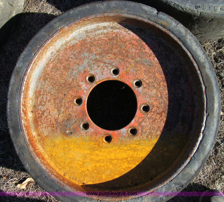 image for item O9000 (4) hard rubber skid steer tires and wheels