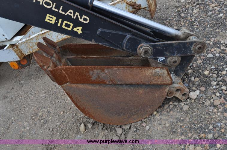 image for item C3033 New Holland B-104 backhoe skid steer attachment