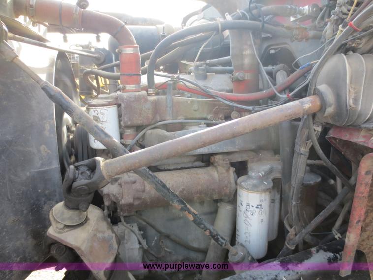 image for item F6557 1990 Mack DM690S roll-off truck