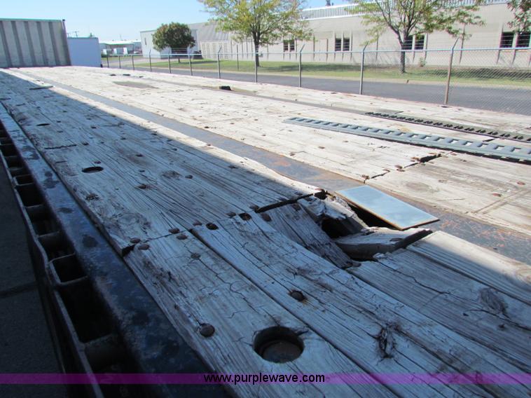 image for item E8121 1993 Transcraft 60 ton tandem axle flatbed trailer