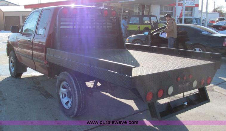 image for item E5875 1997 Toyota T100 DX Xtracab flatbed pickup truck
