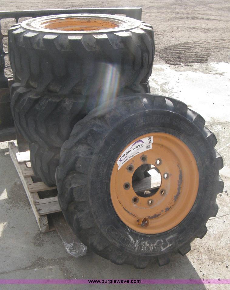 image for item B8406 (4) skid steer wheels and tires
