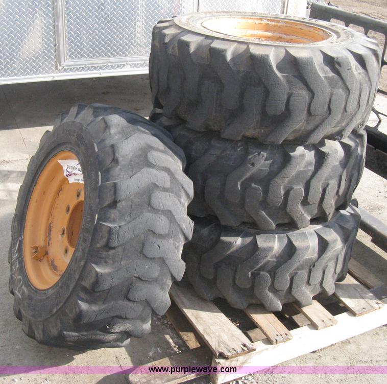 image for item B8406 (4) skid steer wheels and tires