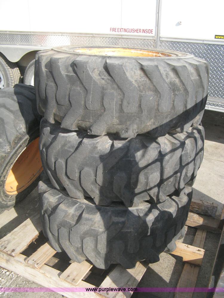 image for item B8406 (4) skid steer wheels and tires