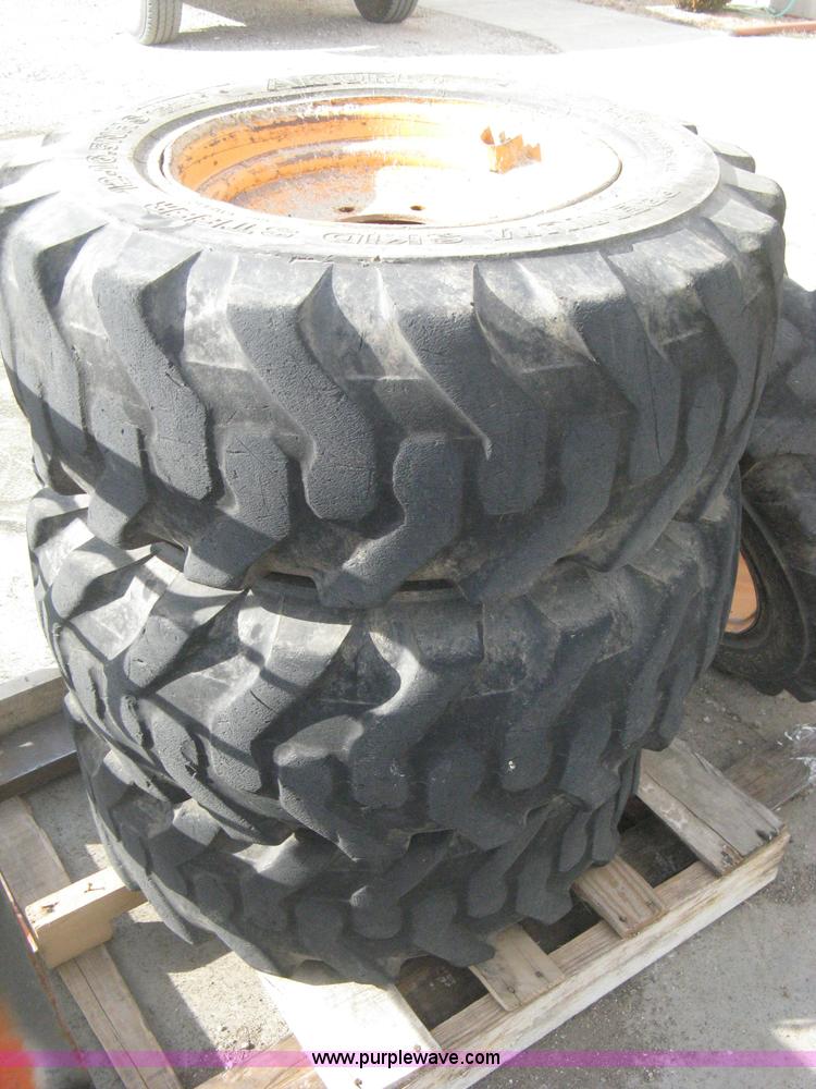 image for item B8406 (4) skid steer wheels and tires