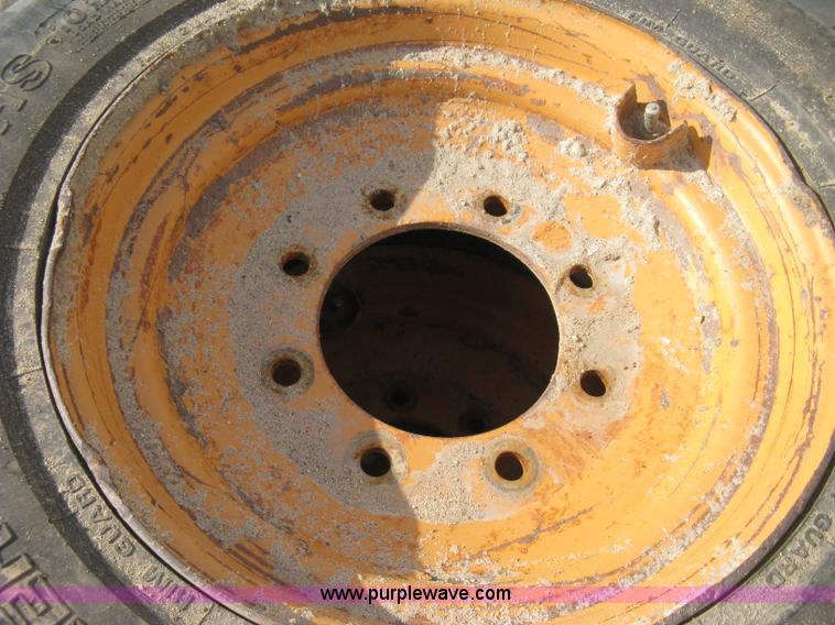image for item B8406 (4) skid steer wheels and tires