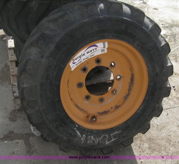 image for item B8406 (4) skid steer wheels and tires