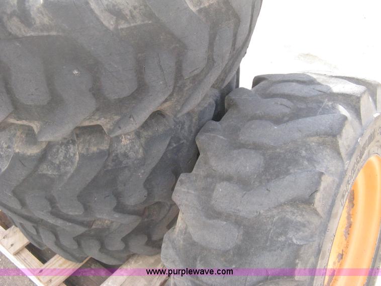 image for item B8406 (4) skid steer wheels and tires