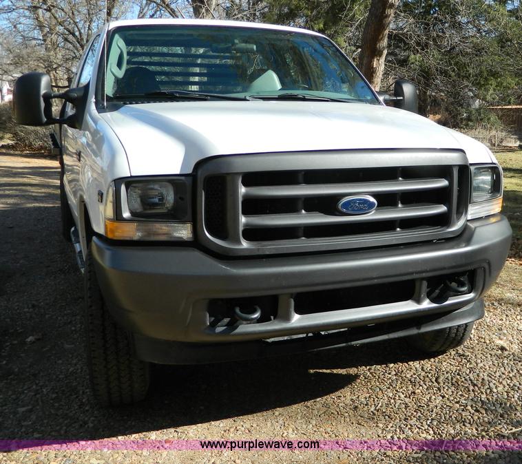 image for item G7537 2004 Ford F350 XL Super Duty flatbed pickup truck