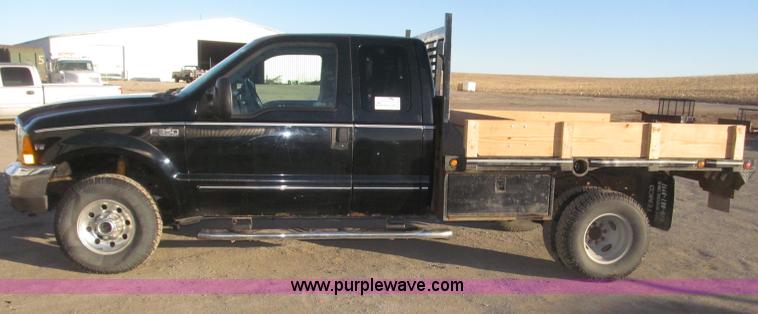 image for item B5400 1999 Ford F350 XLT SuperCab flatbed truck