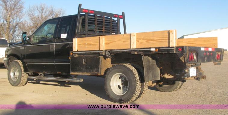 image for item B5400 1999 Ford F350 XLT SuperCab flatbed truck