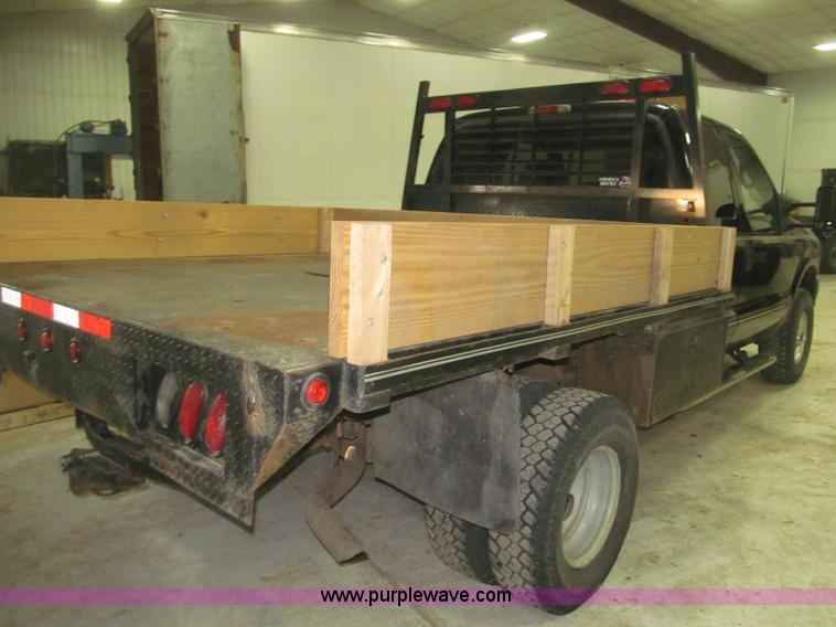 image for item B5400 1999 Ford F350 XLT SuperCab flatbed truck