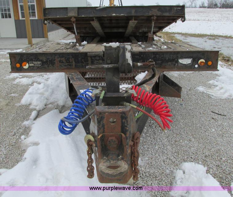 image for item F4762 1999 Dynaweld tilt flatbed triple axle trailer