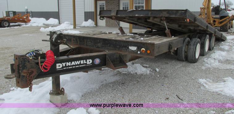 image for item F4762 1999 Dynaweld tilt flatbed triple axle trailer