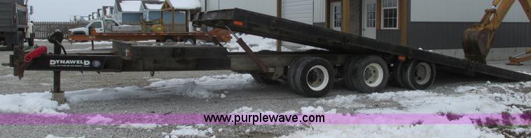 image for item F4762 1999 Dynaweld tilt flatbed triple axle trailer