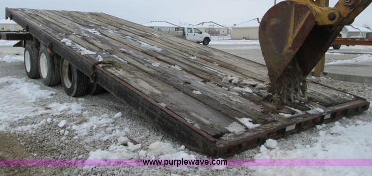 image for item F4762 1999 Dynaweld tilt flatbed triple axle trailer