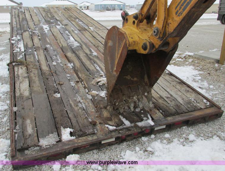 image for item F4762 1999 Dynaweld tilt flatbed triple axle trailer