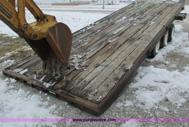 image for item F4762 1999 Dynaweld tilt flatbed triple axle trailer