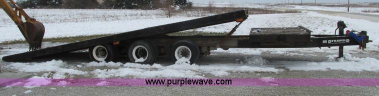 image for item F4762 1999 Dynaweld tilt flatbed triple axle trailer