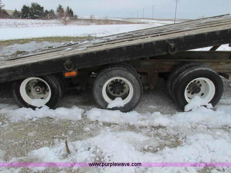 image for item F4762 1999 Dynaweld tilt flatbed triple axle trailer
