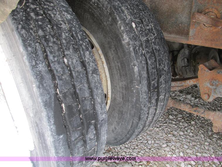 image for item F4762 1999 Dynaweld tilt flatbed triple axle trailer