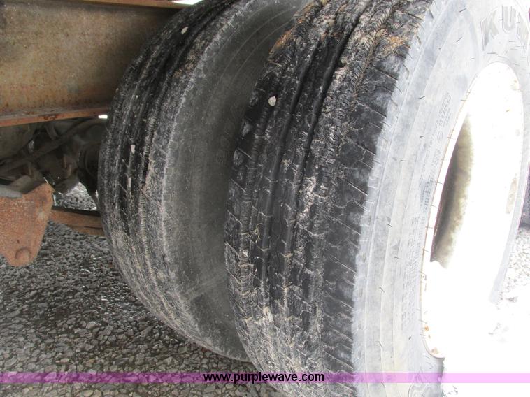 image for item F4762 1999 Dynaweld tilt flatbed triple axle trailer