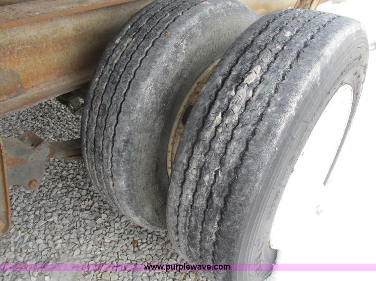 image for item F4762 1999 Dynaweld tilt flatbed triple axle trailer