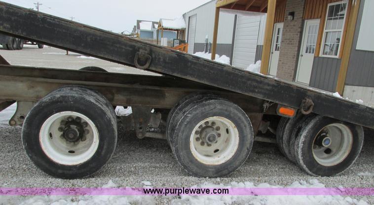 image for item F4762 1999 Dynaweld tilt flatbed triple axle trailer