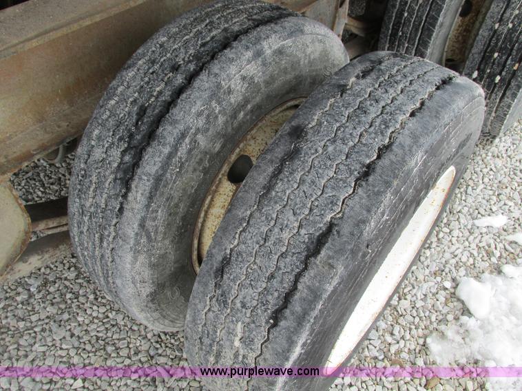 image for item F4762 1999 Dynaweld tilt flatbed triple axle trailer