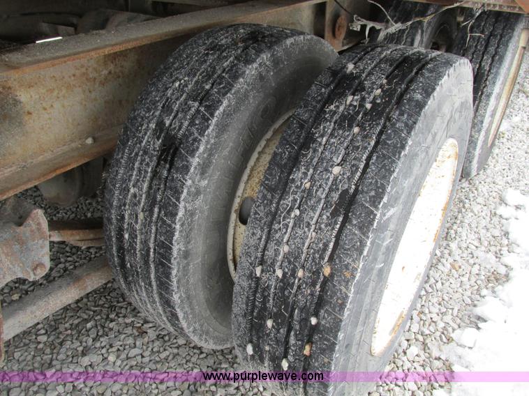 image for item F4762 1999 Dynaweld tilt flatbed triple axle trailer