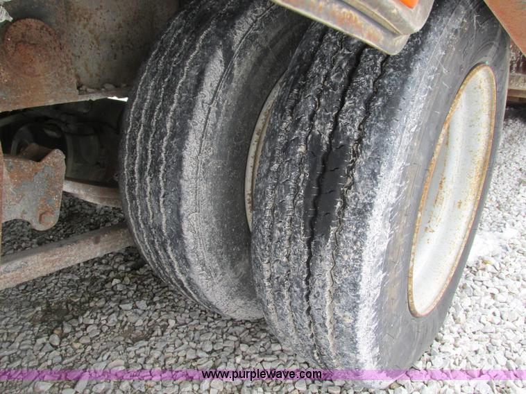 image for item F4762 1999 Dynaweld tilt flatbed triple axle trailer