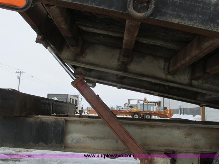 image for item F4762 1999 Dynaweld tilt flatbed triple axle trailer