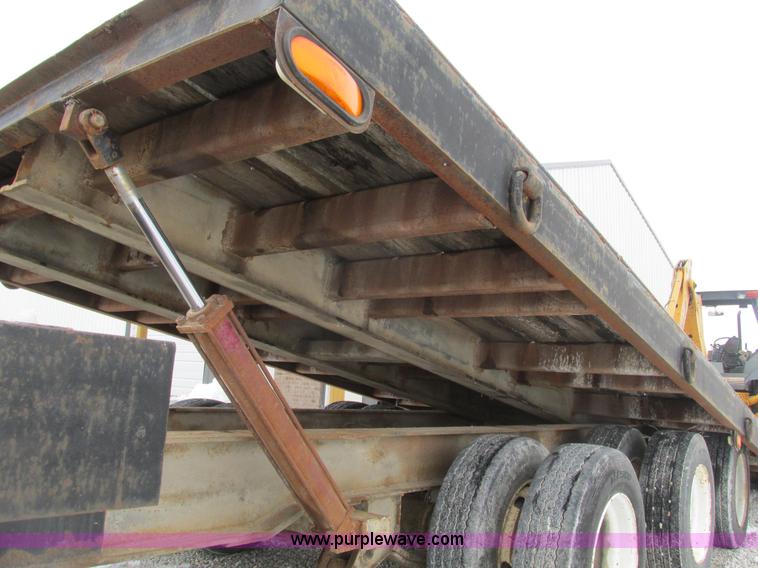 image for item F4762 1999 Dynaweld tilt flatbed triple axle trailer