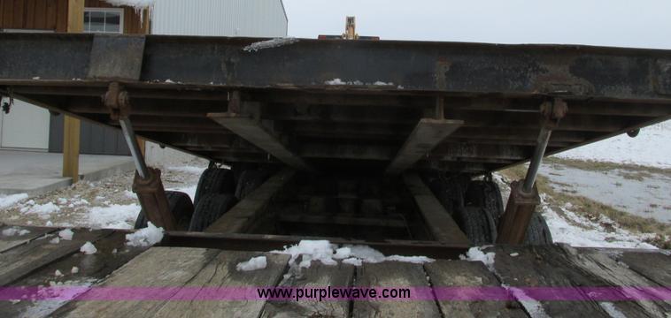 image for item F4762 1999 Dynaweld tilt flatbed triple axle trailer