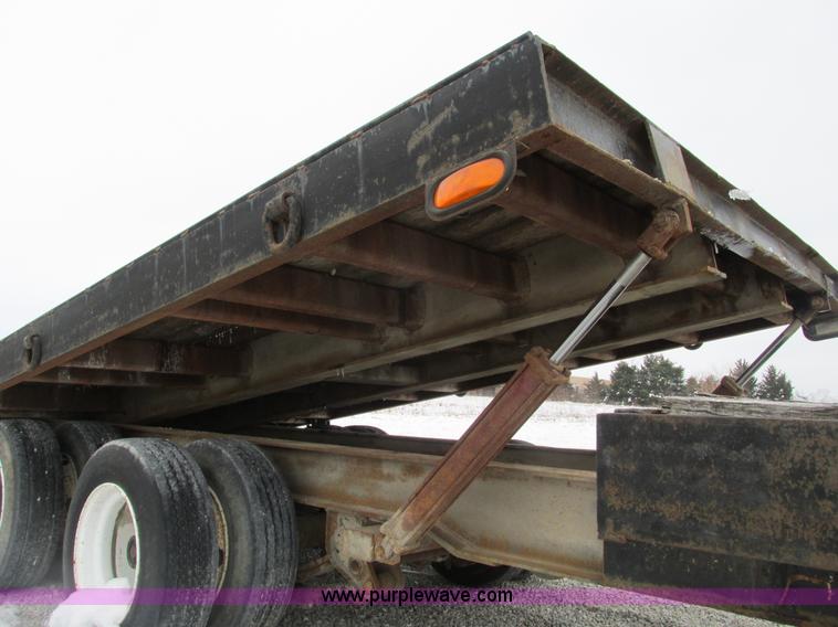 image for item F4762 1999 Dynaweld tilt flatbed triple axle trailer
