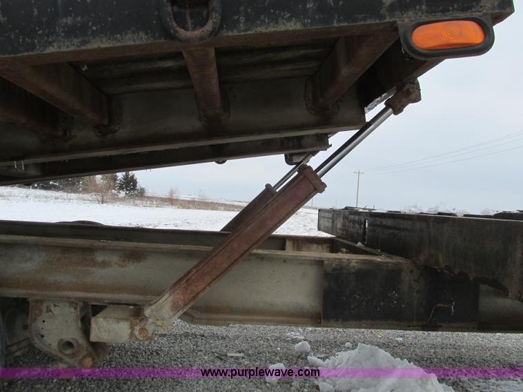 image for item F4762 1999 Dynaweld tilt flatbed triple axle trailer