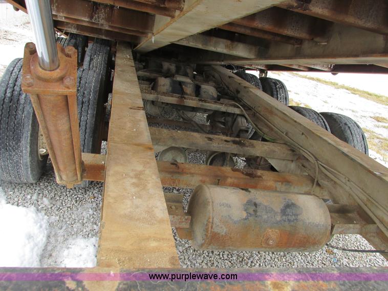 image for item F4762 1999 Dynaweld tilt flatbed triple axle trailer