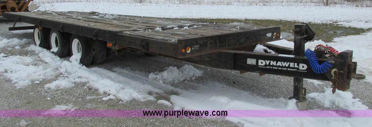 image for item F4762 1999 Dynaweld tilt flatbed triple axle trailer