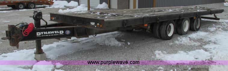 image for item F4762 1999 Dynaweld tilt flatbed triple axle trailer