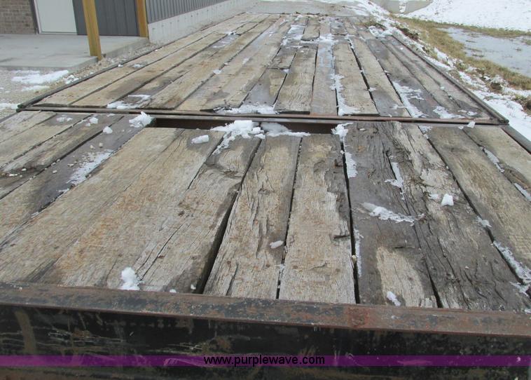 image for item F4762 1999 Dynaweld tilt flatbed triple axle trailer