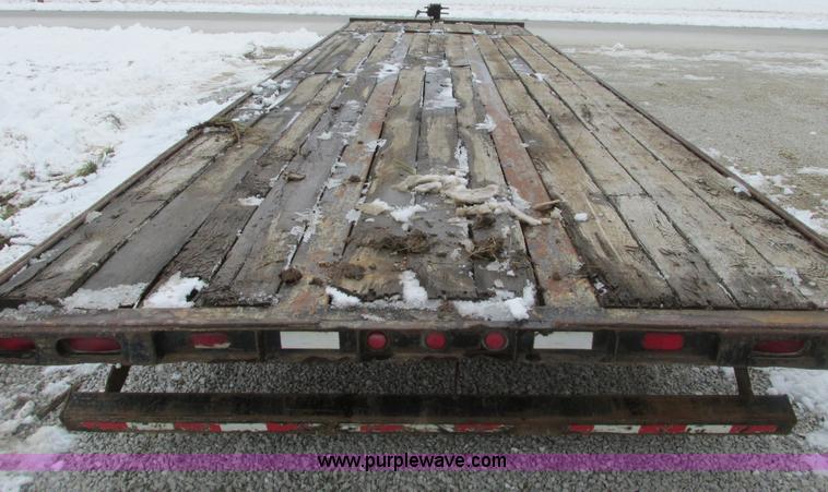 image for item F4762 1999 Dynaweld tilt flatbed triple axle trailer