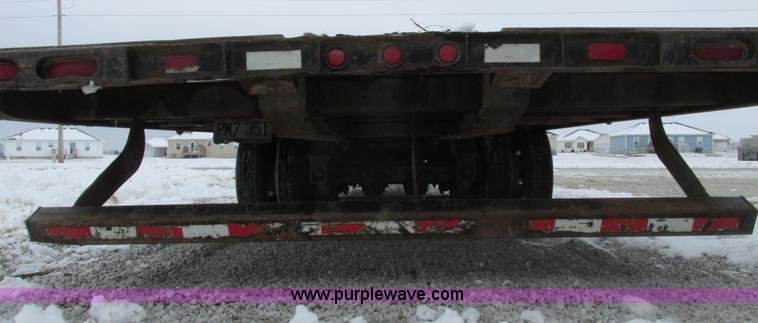 image for item F4762 1999 Dynaweld tilt flatbed triple axle trailer