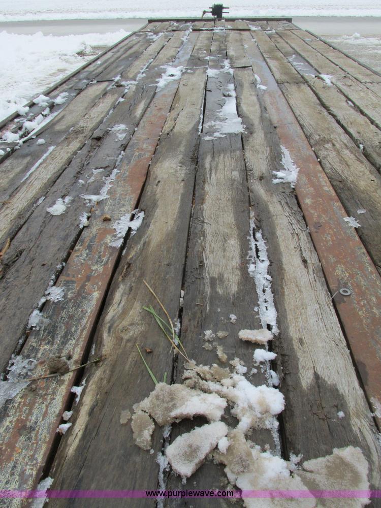 image for item F4762 1999 Dynaweld tilt flatbed triple axle trailer