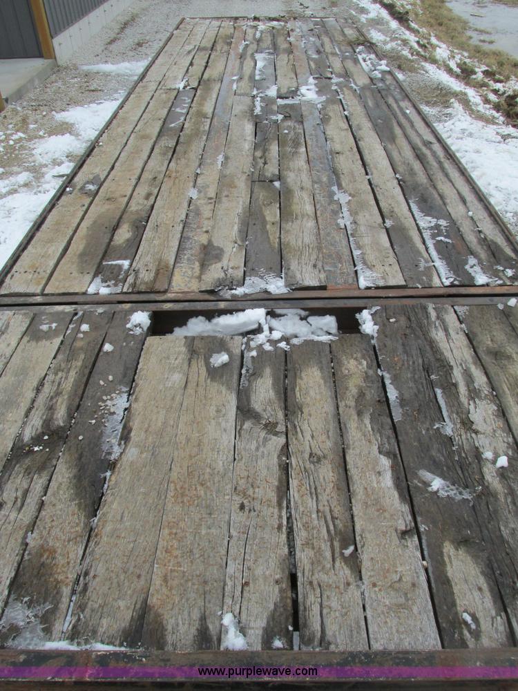 image for item F4762 1999 Dynaweld tilt flatbed triple axle trailer