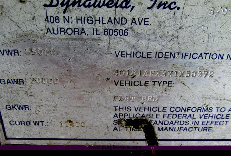 image for item F4762 1999 Dynaweld tilt flatbed triple axle trailer