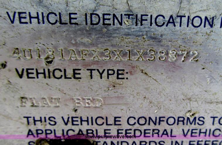 image for item F4762 1999 Dynaweld tilt flatbed triple axle trailer